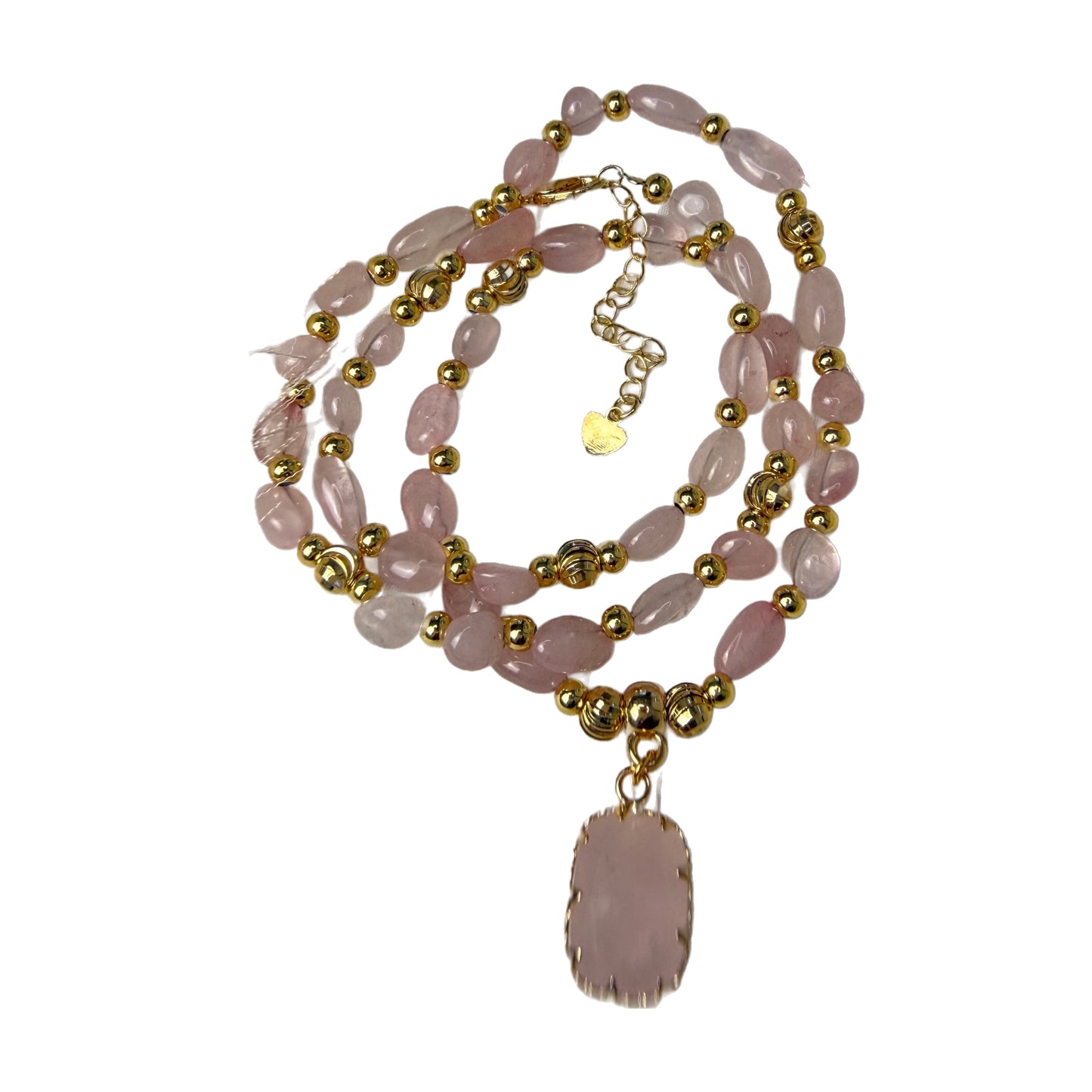 Detail of tumbled natural rose quartz nugget beads in pale blush pink with gold accent beads and heart charm