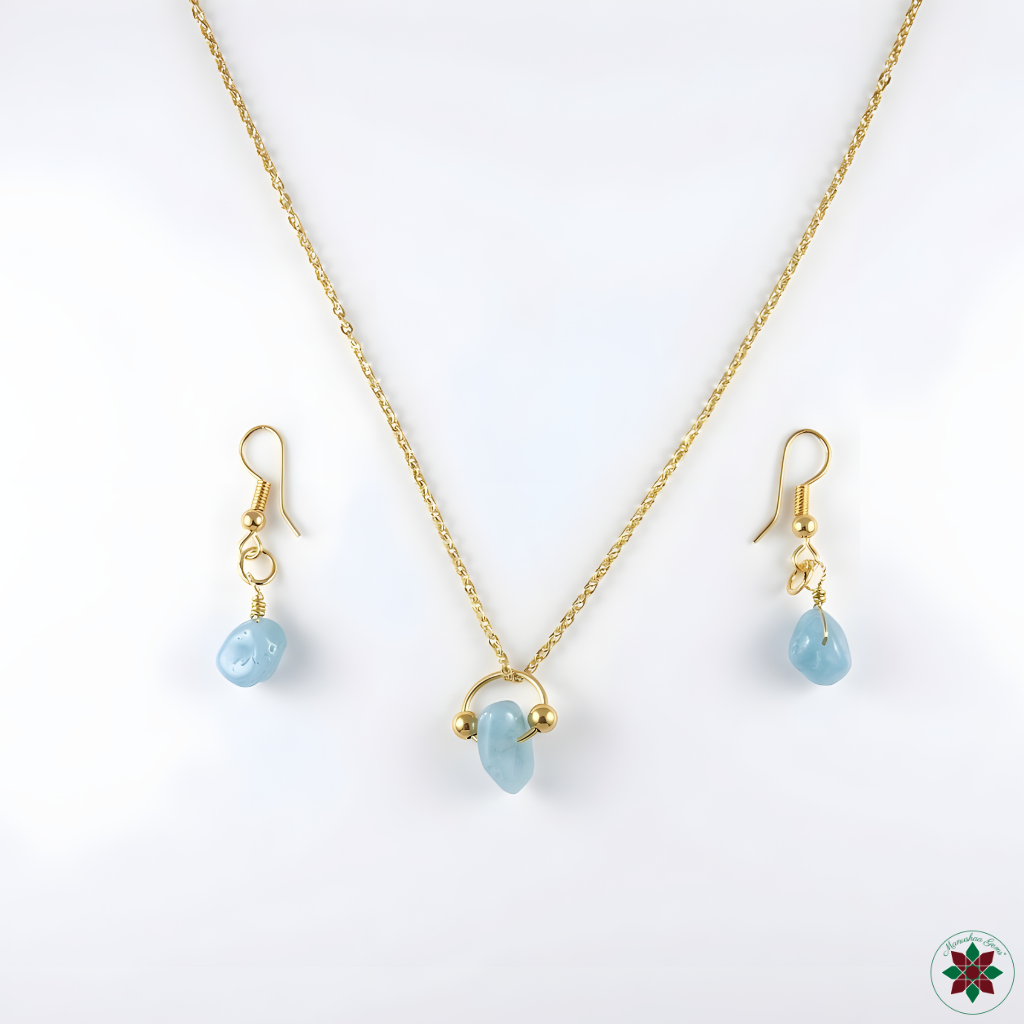 Blue Peruvian Opal necklace and drop earrings flat lay on ivory — calming crystal jewellery set by Manushaa Gems