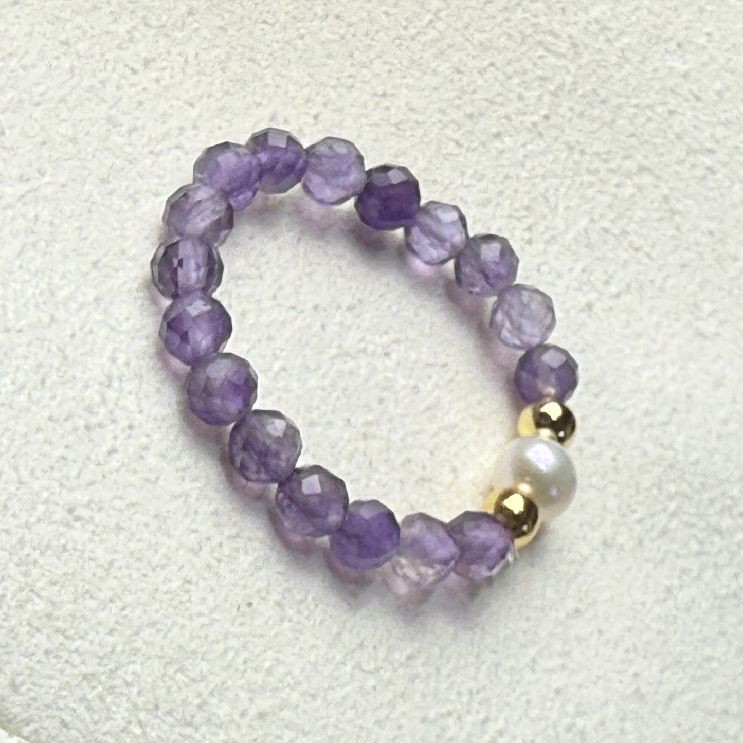 Amethyst and freshwater pearl stretch ring on cream suede – handmade February birthstone ring by Manushaa Gems
