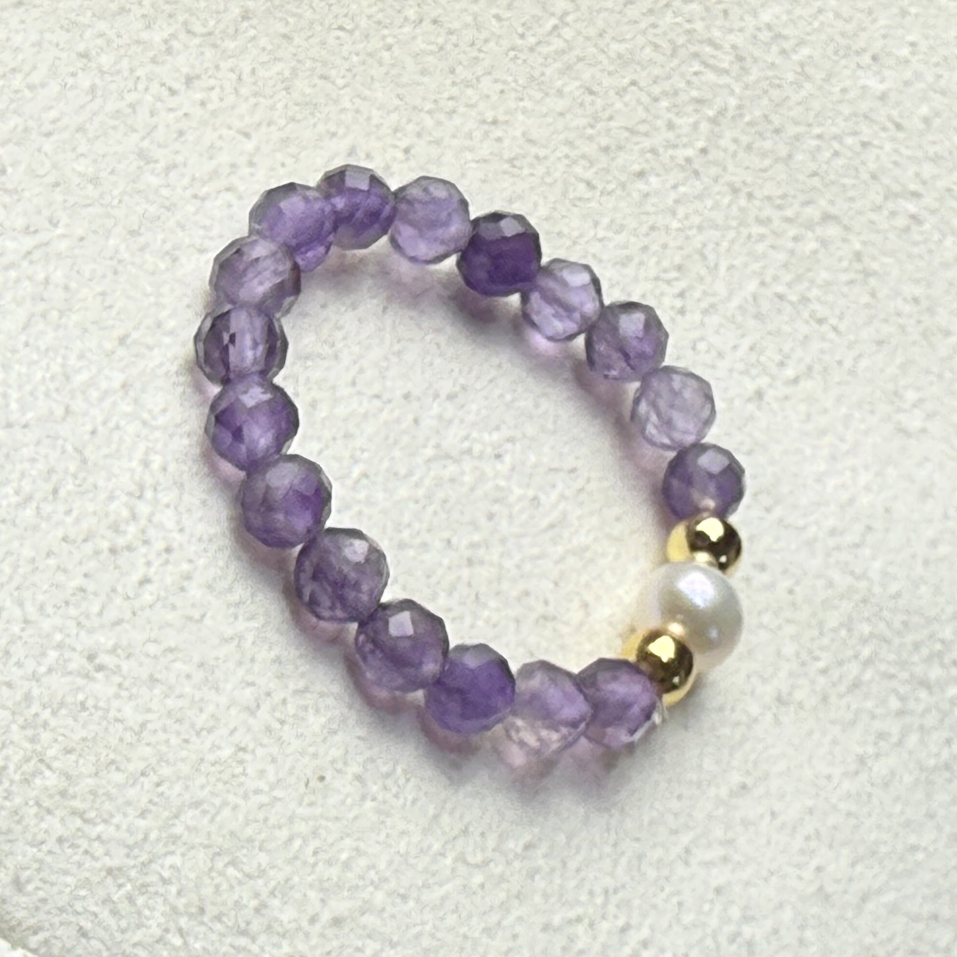 Amethyst and freshwater pearl stretch ring on cream suede – handmade February birthstone ring by Manushaa Gems