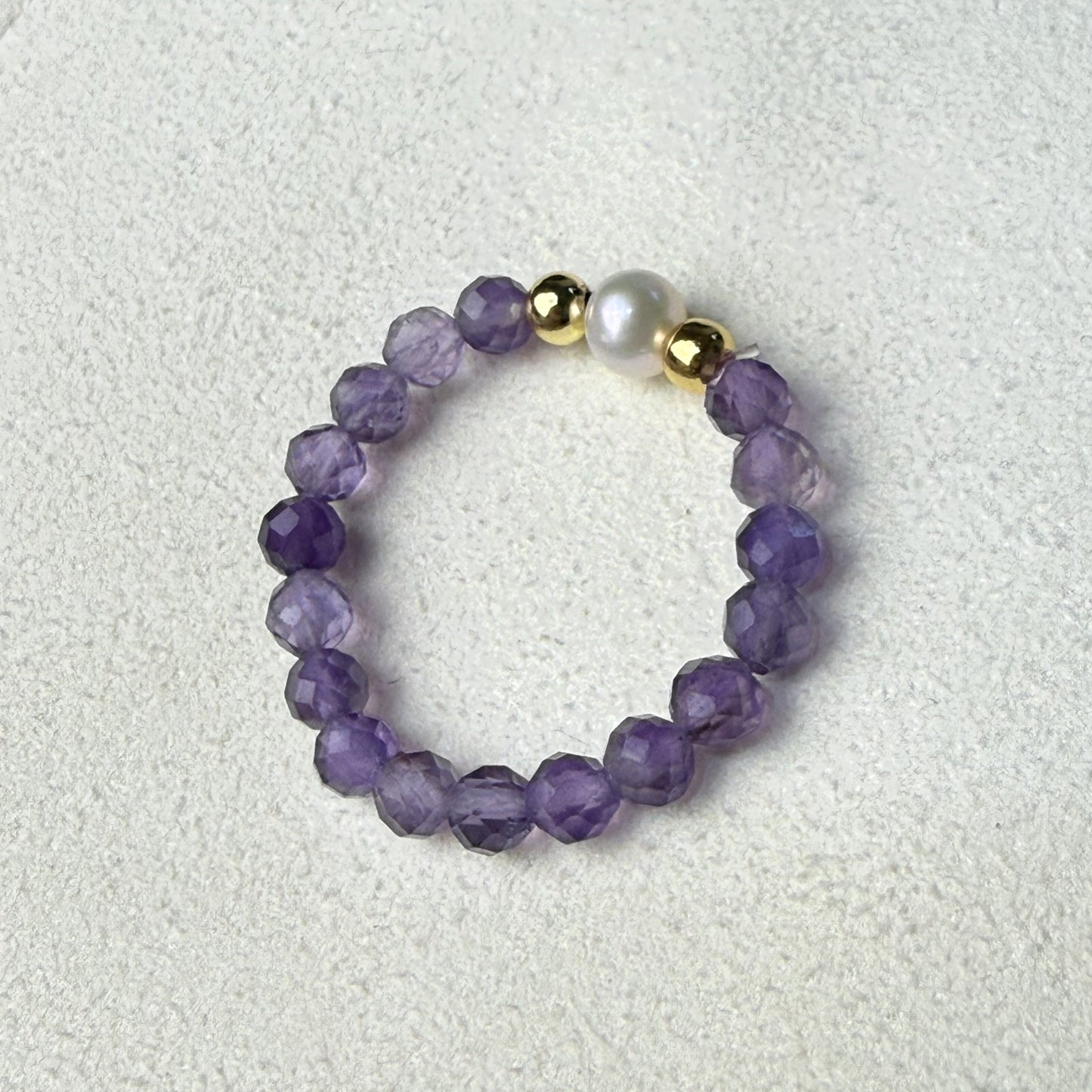 Macro detail of faceted amethyst beads and unique freshwater pearl – handmade stretch ring by Manushaa Gems