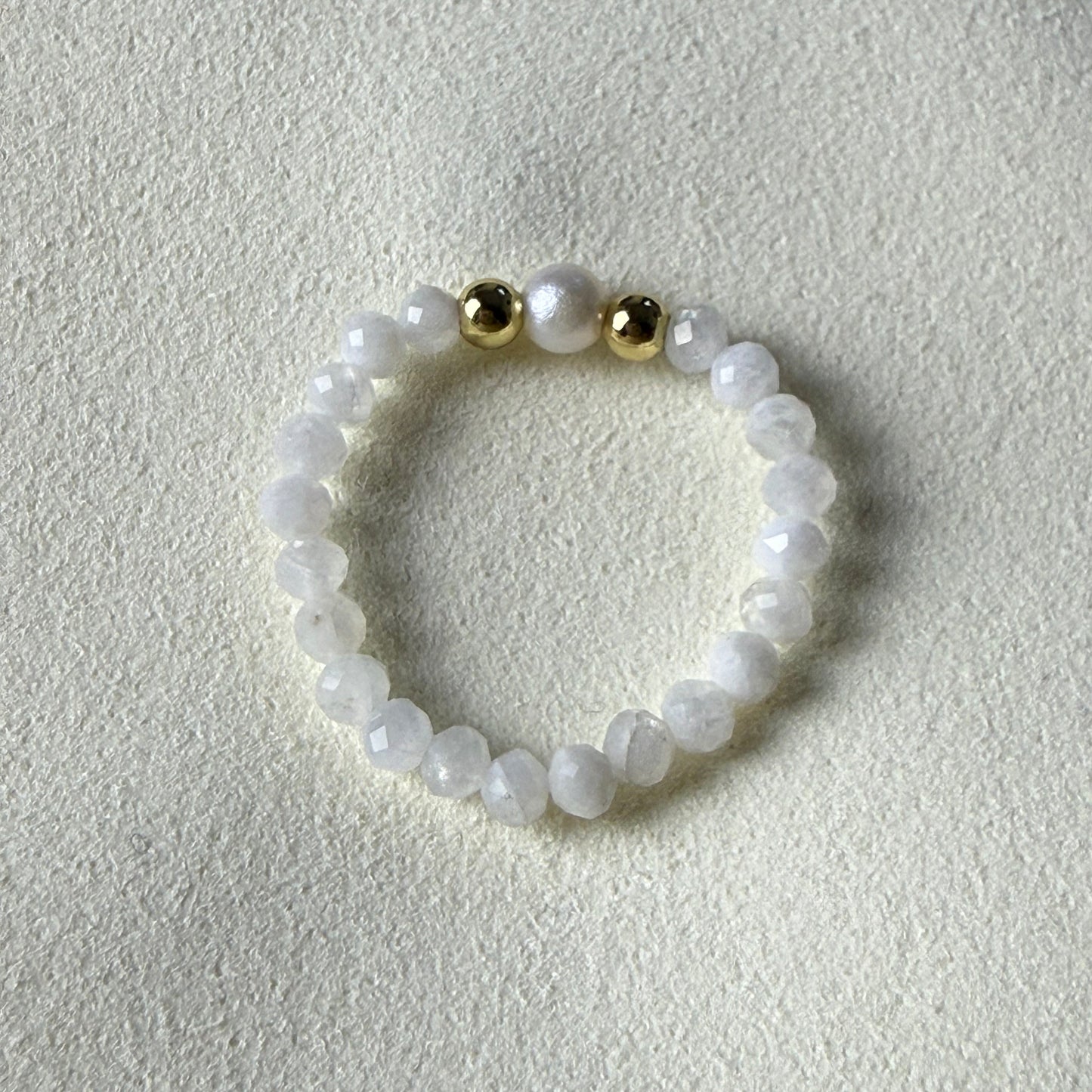 Close-up of iridescent 3mm faceted moonstone beads with freshwater pearl and gold accents – Manushaa Gems