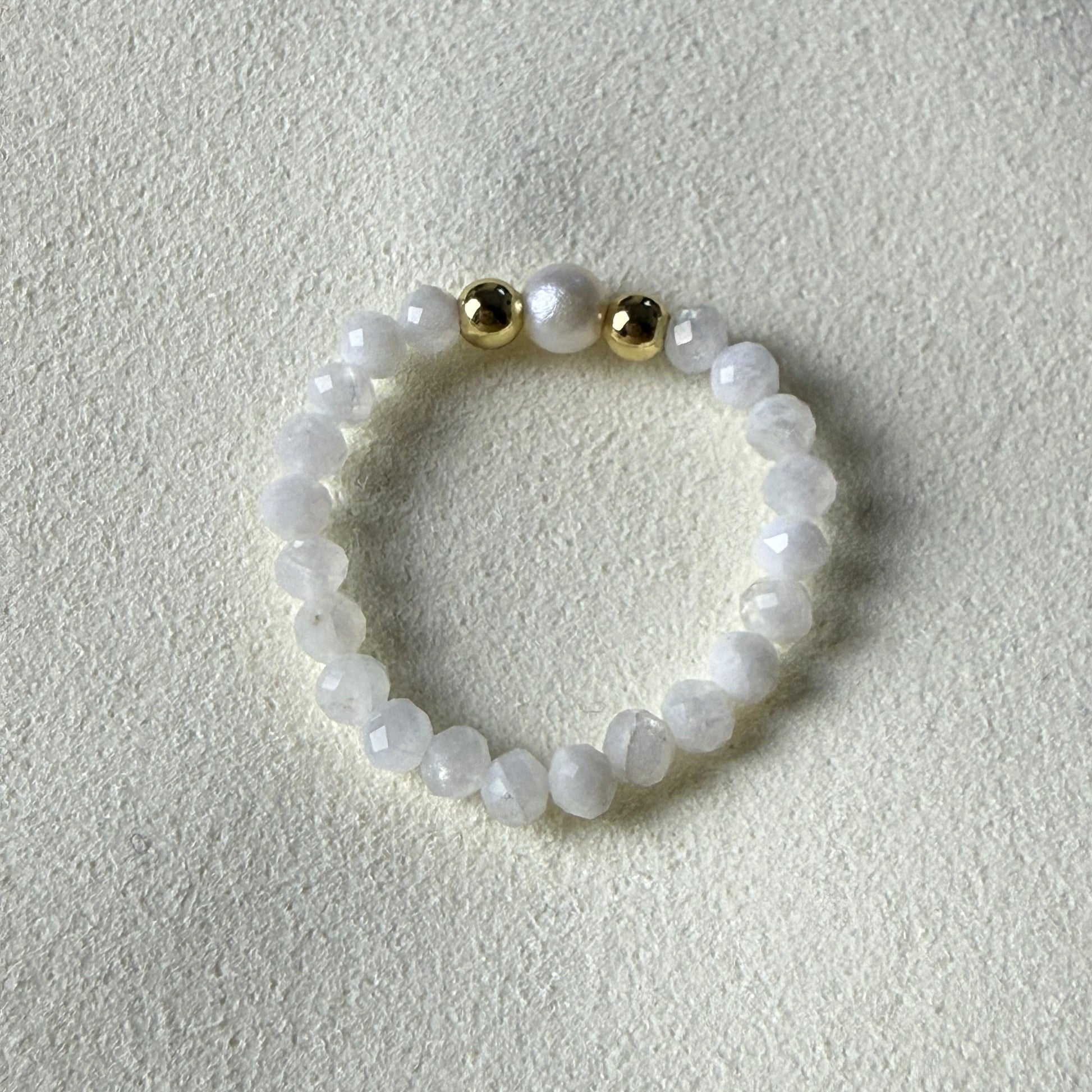 Close-up of iridescent 3mm faceted moonstone beads with freshwater pearl and gold accents – Manushaa Gems