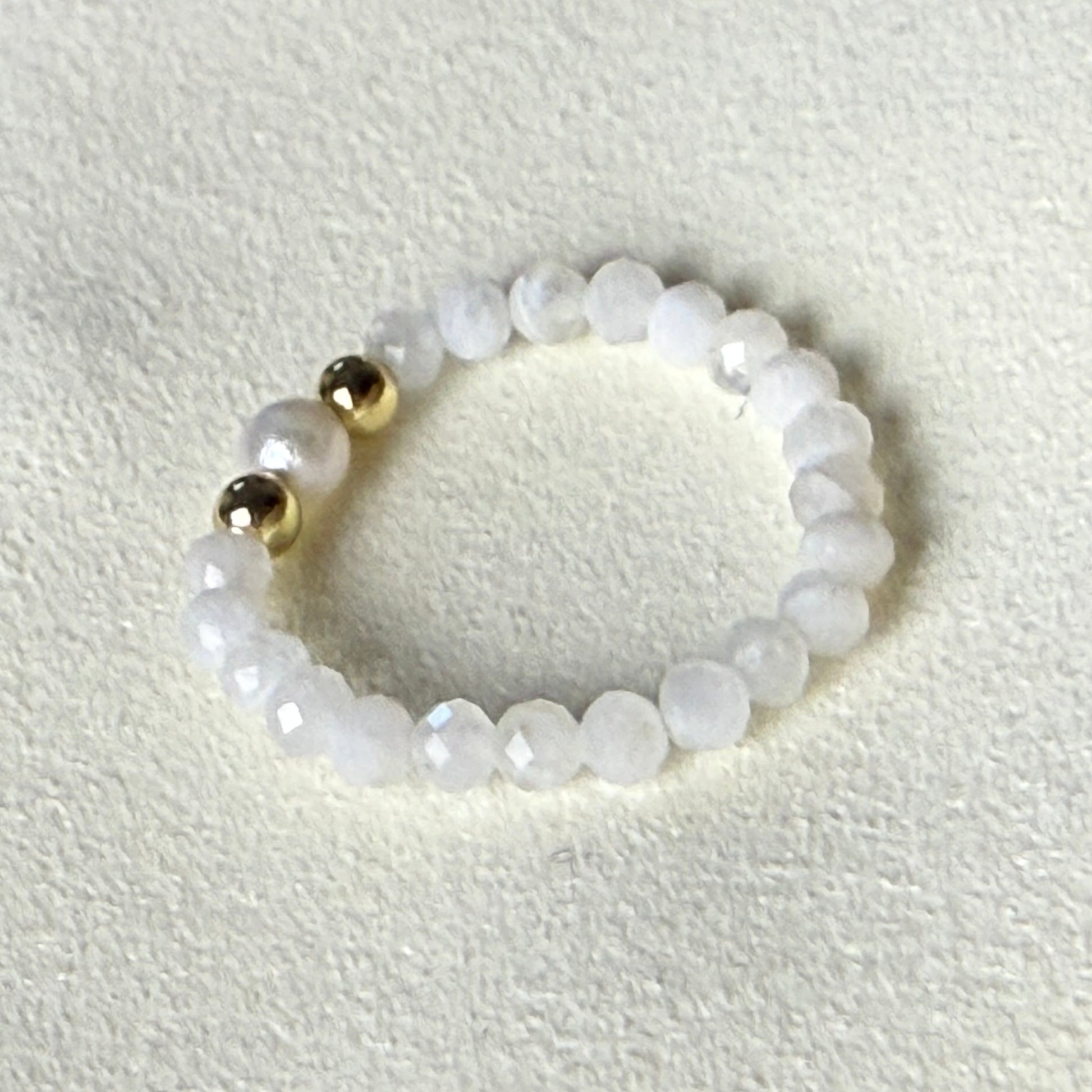 Moonstone and freshwater pearl stretch ring glowing on cream suede – handmade June birthstone ring by Manushaa Gems
