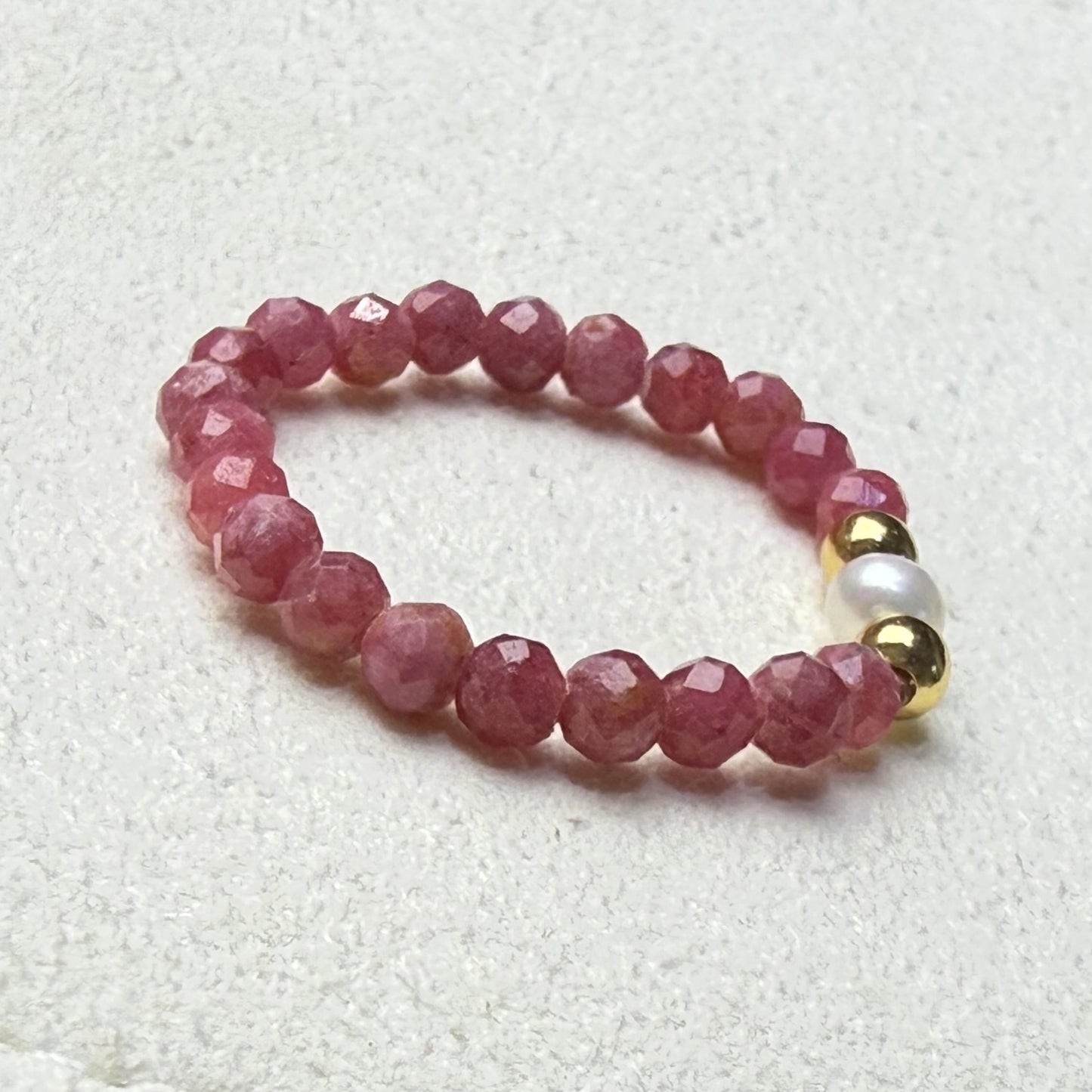 Close-up of pink and black veined rhodonite beads with freshwater pearl and gold accents – Manushaa Gems