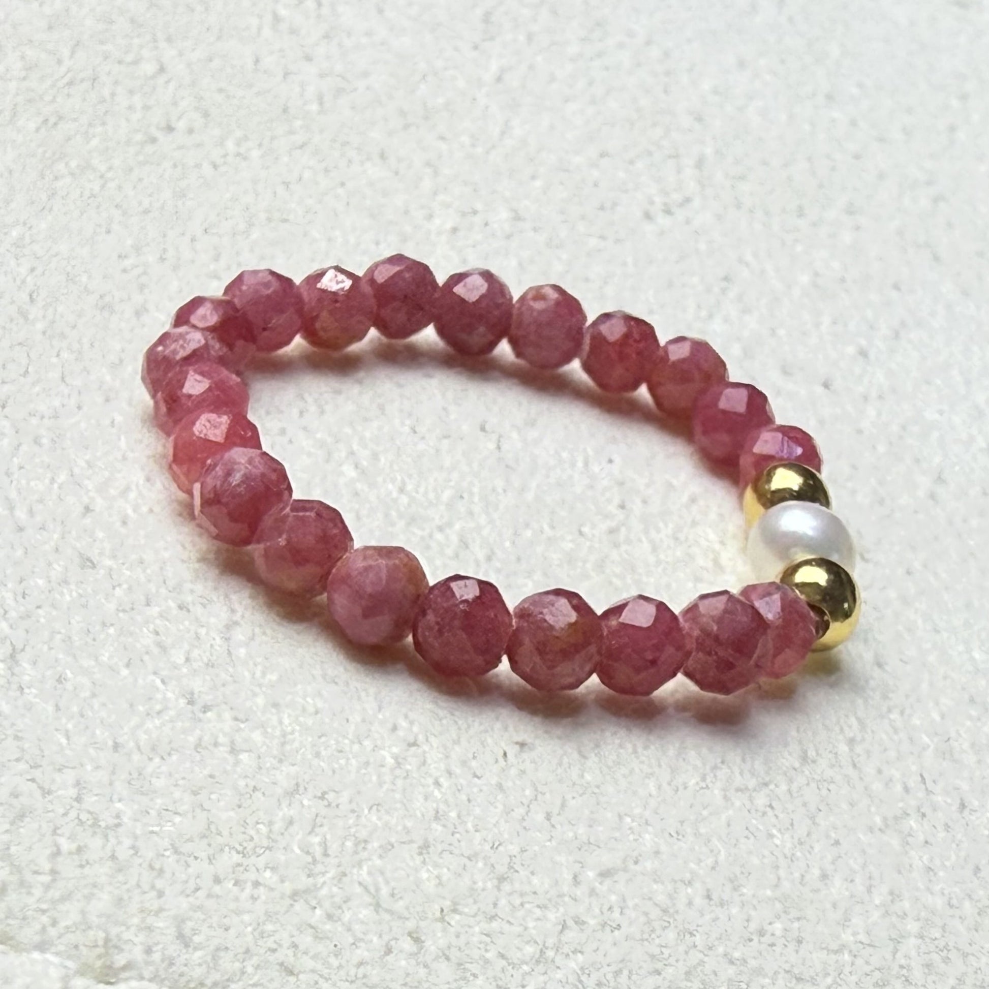 Close-up of pink and black veined rhodonite beads with freshwater pearl and gold accents – Manushaa Gems