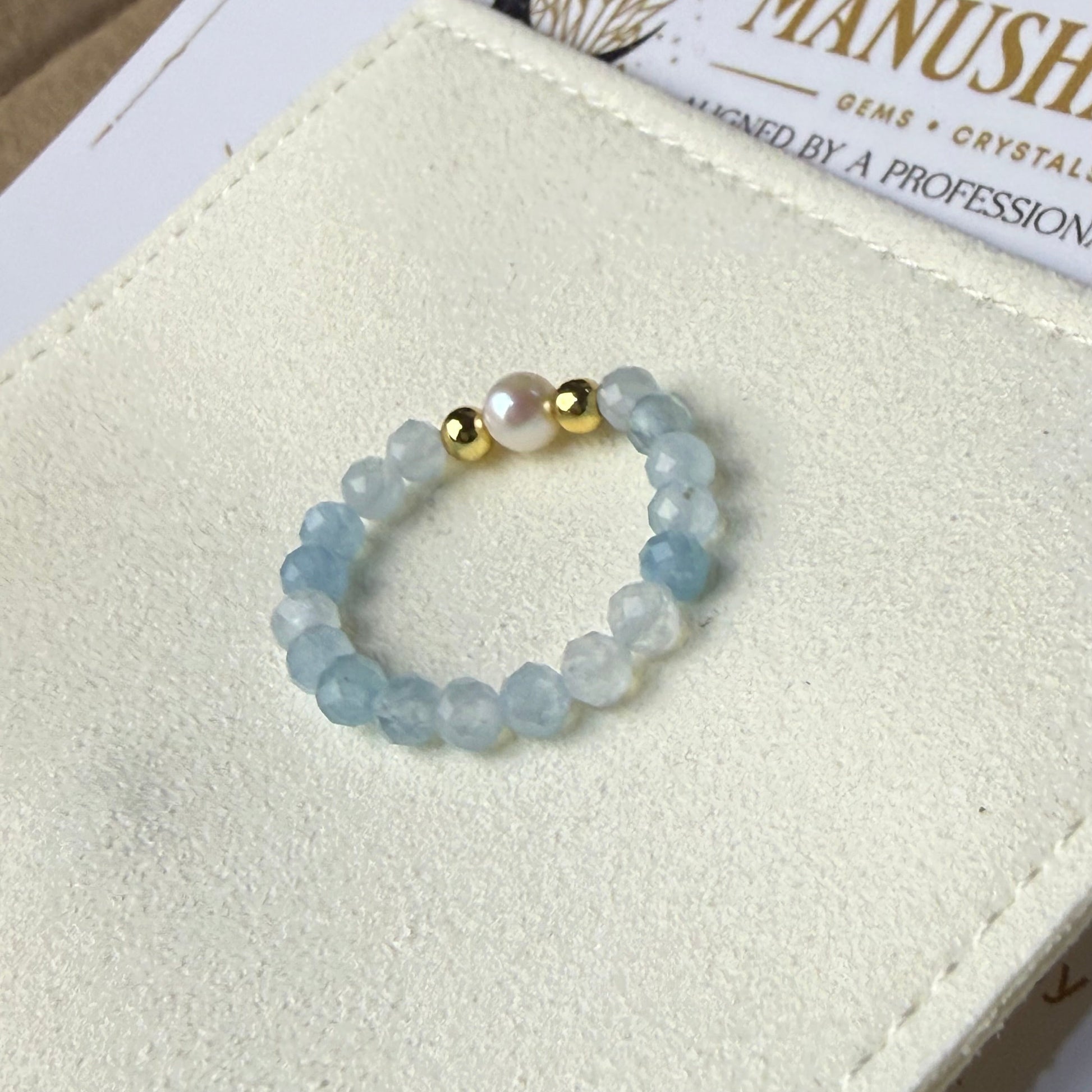 Aquamarine and freshwater pearl stretch ring on cream suede – handmade March birthstone ring by Manushaa Gems