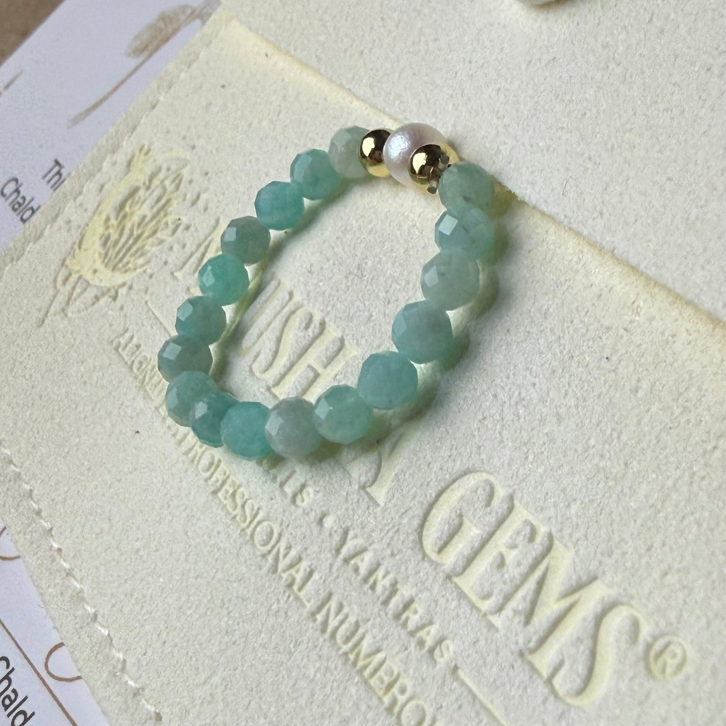 Close-up of turquoise-green faceted amazonite beads with freshwater pearl and gold accents – Manushaa Gems