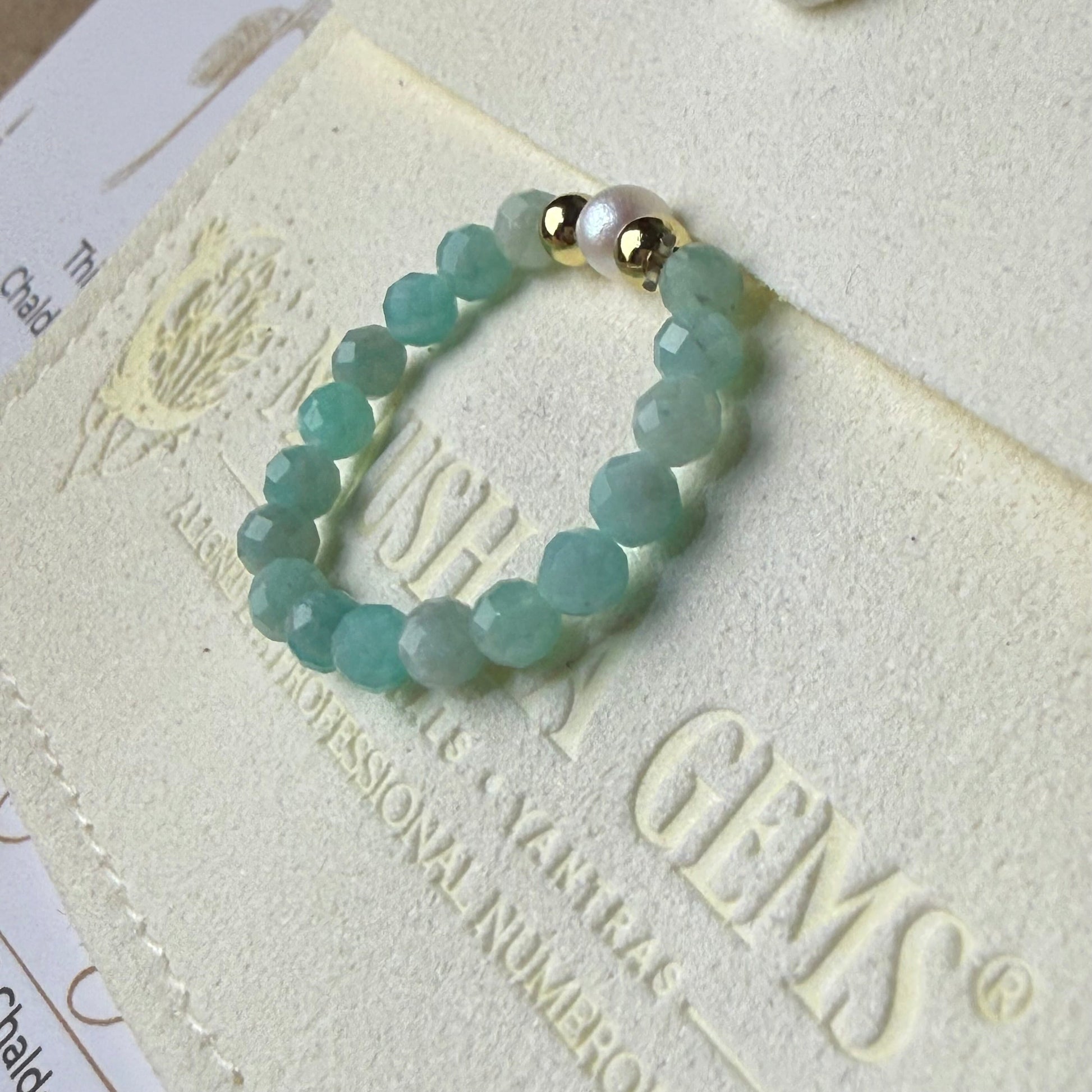 Close-up of turquoise-green faceted amazonite beads with freshwater pearl and gold accents – Manushaa Gems