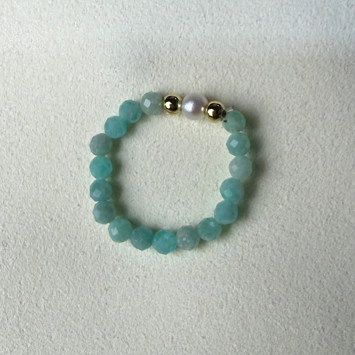 Macro detail of faceted Brazilian amazonite beads and unique freshwater pearl – handmade stretch ring by Manushaa Gems