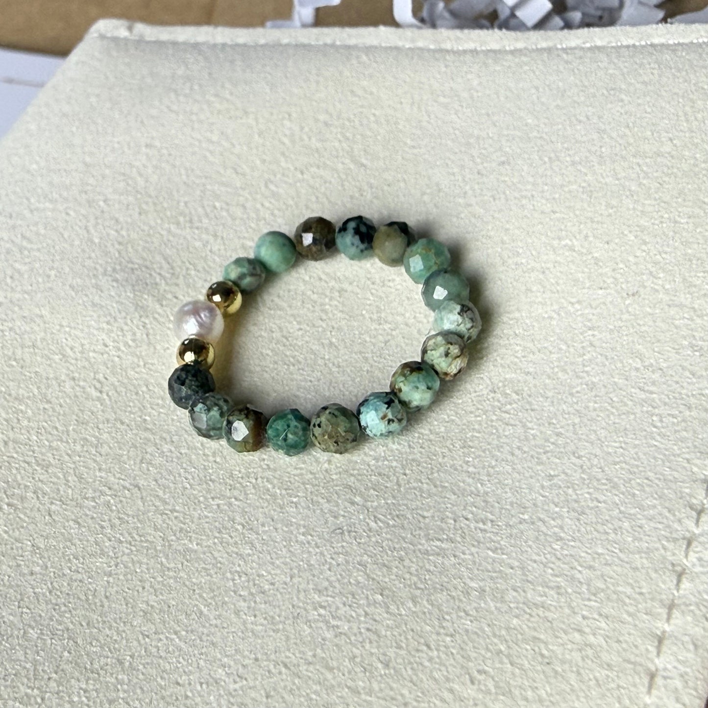 Close-up of teal green speckled African turquoise beads with freshwater pearl and gold accents – Manushaa Gems