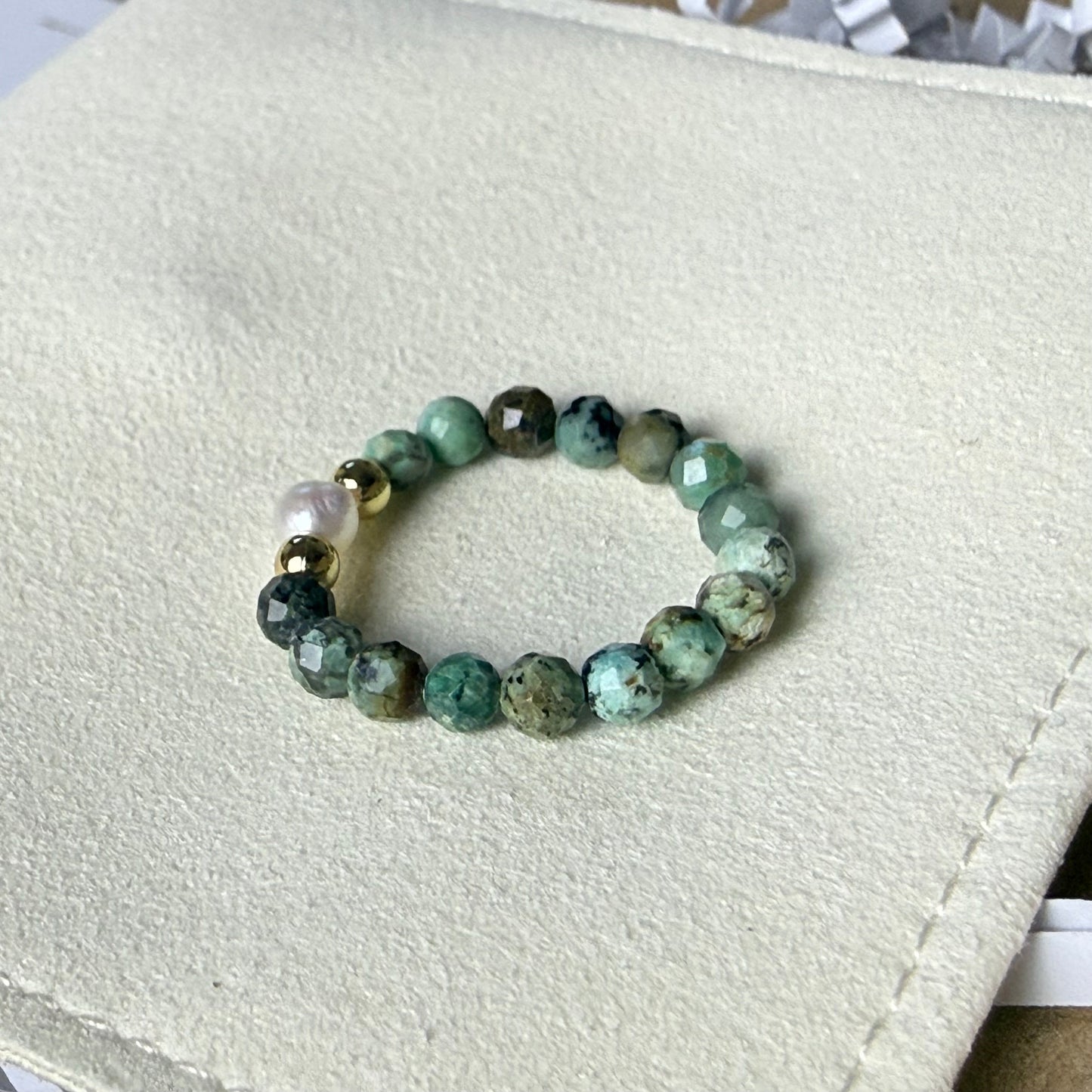 Macro detail of faceted African turquoise beads and unique freshwater pearl – handmade stretch ring by Manushaa Gems