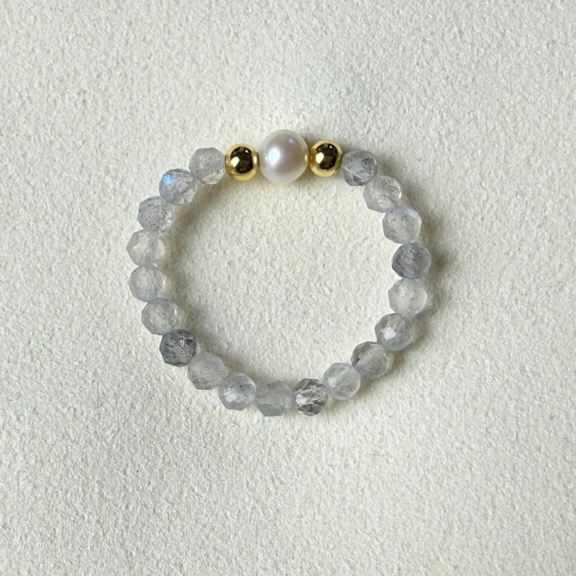 Macro detail of faceted labradorite beads and unique freshwater pearl – handmade stretch ring by Manushaa Gems