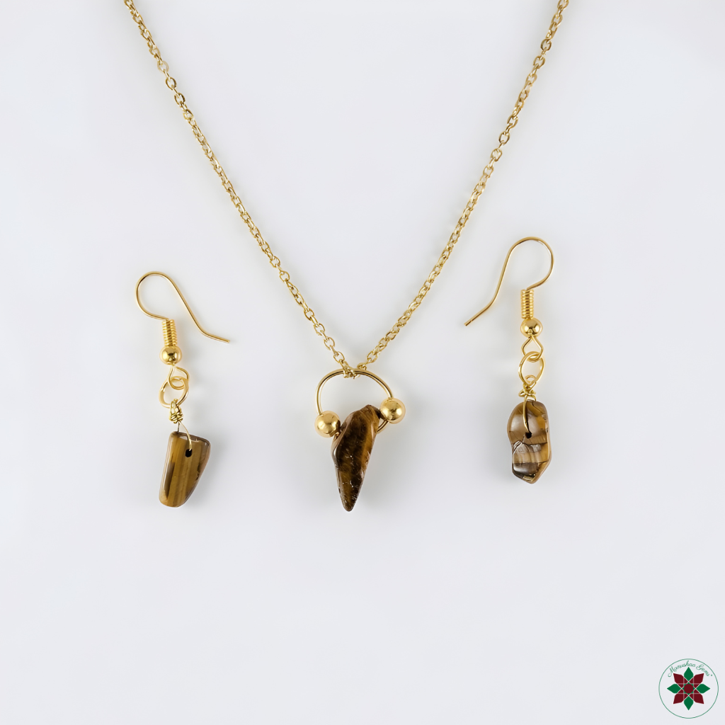 Tiger eye necklace and drop earrings flat lay on ivory — confidence crystal jewellery set by Manushaa Gems
