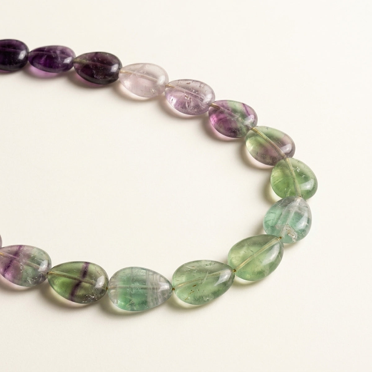 Natural purple and green Fluorite teardrop beads close-up