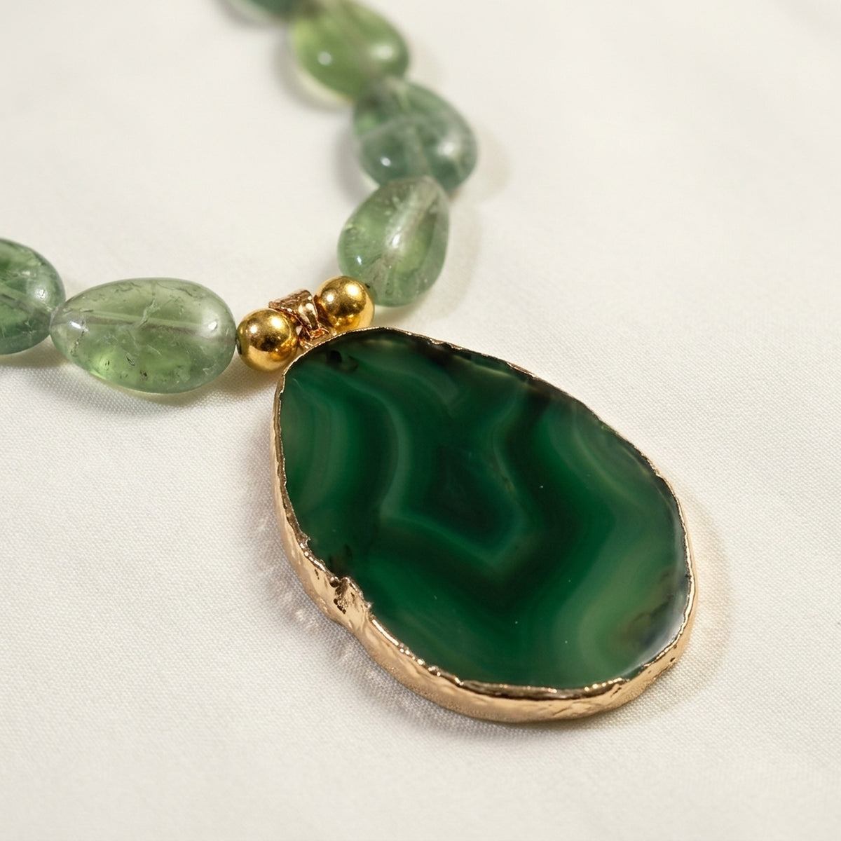 Natural green agate slice pendant with gold-plated edge close-up