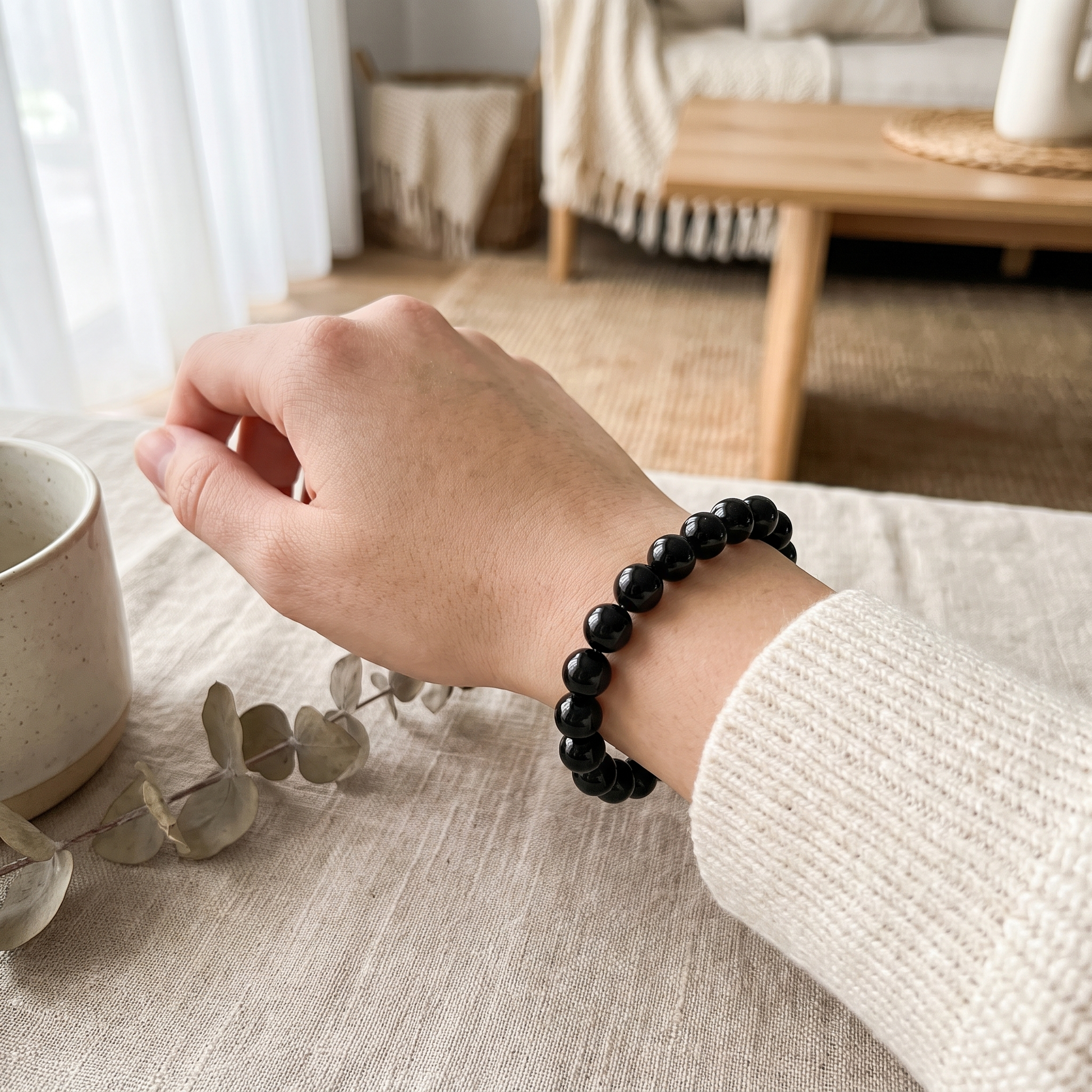 Woman wearing Black Tourmaline crystal bracelet on wrist - protection and grounding jewellery