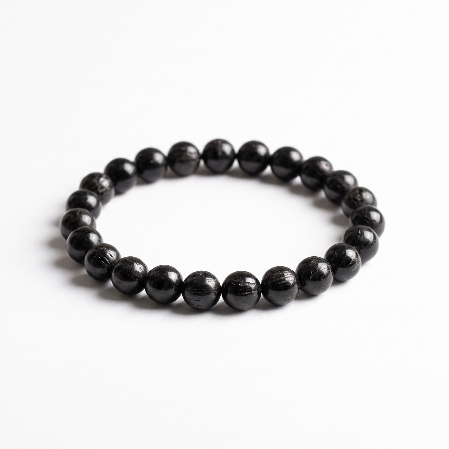 Natural Black Tourmaline 8mm crystal beaded stretch bracelet on white background - Manushaa Gems