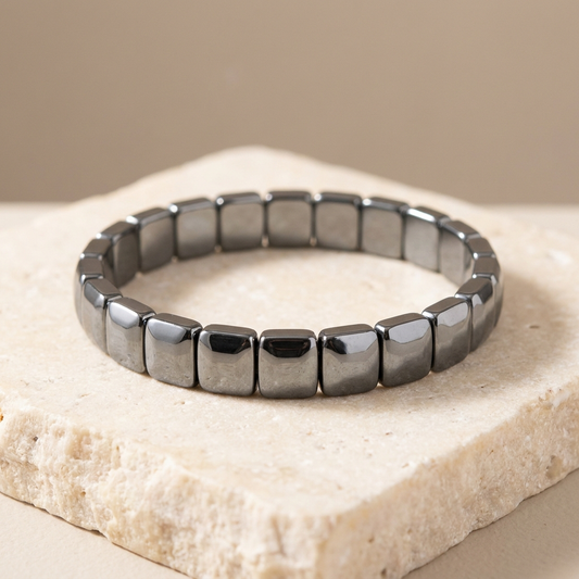 Natural hematite bracelet with mirror-polished flat square beads, coiled on ivory stone - Manushaa Gems UK