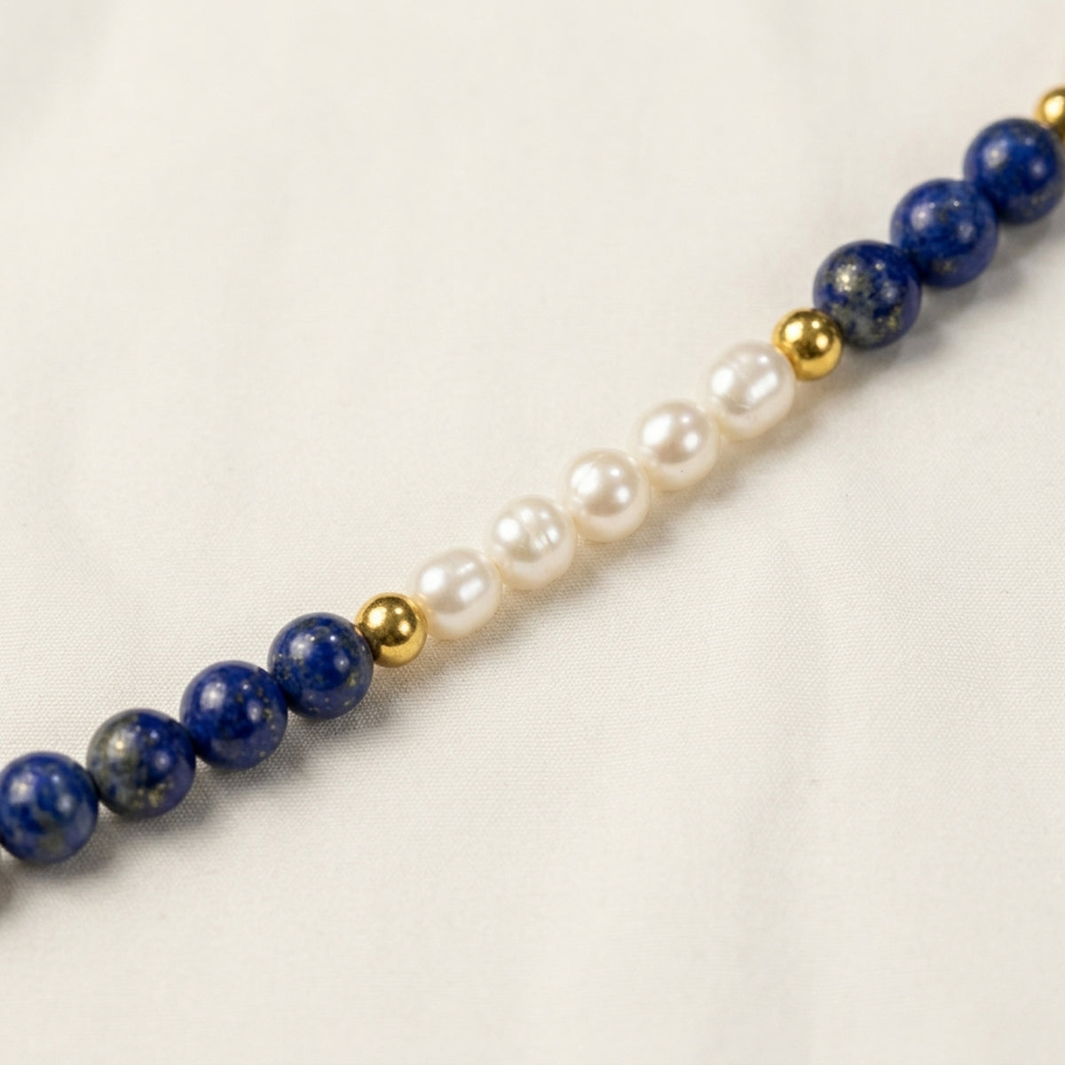 Natural Lapis Lazuli beads with irregular freshwater rice pearls and gold-tone spacers