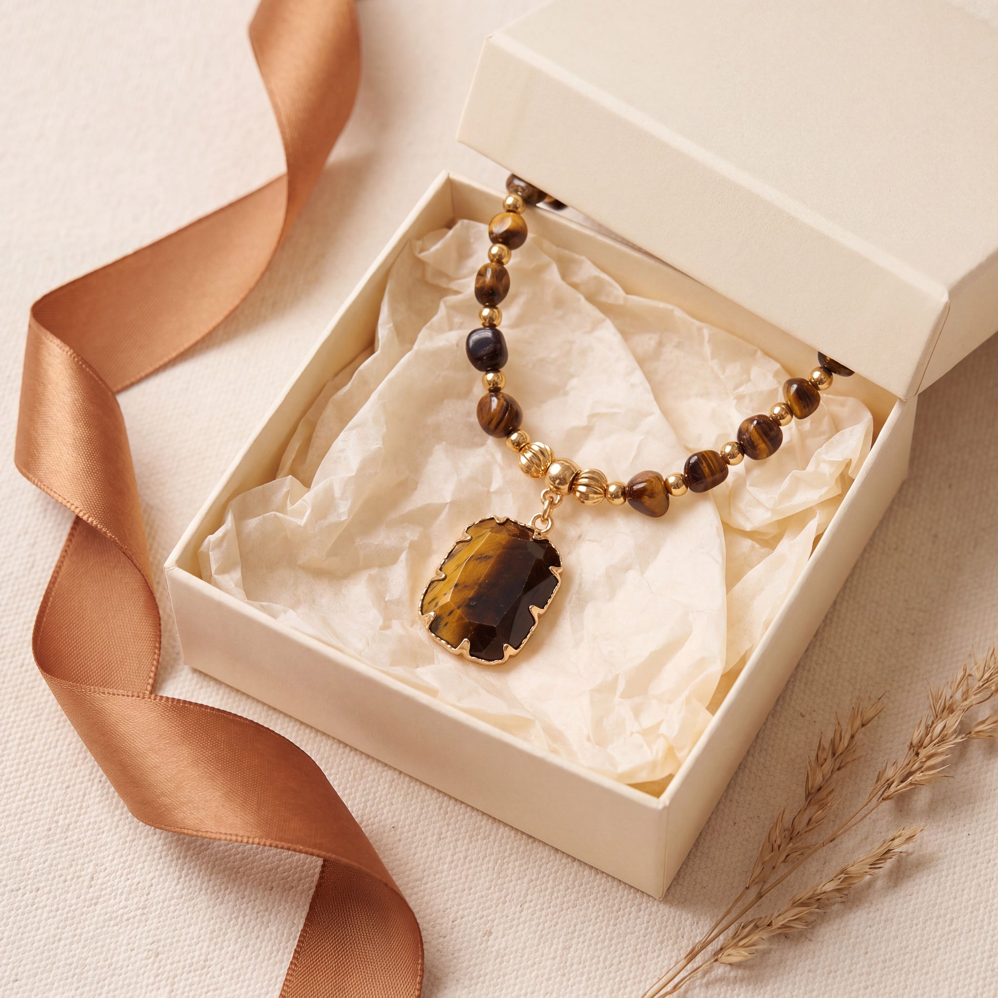 Tiger eye healing crystal necklace presented in a cream gift box with a caramel satin ribbon
