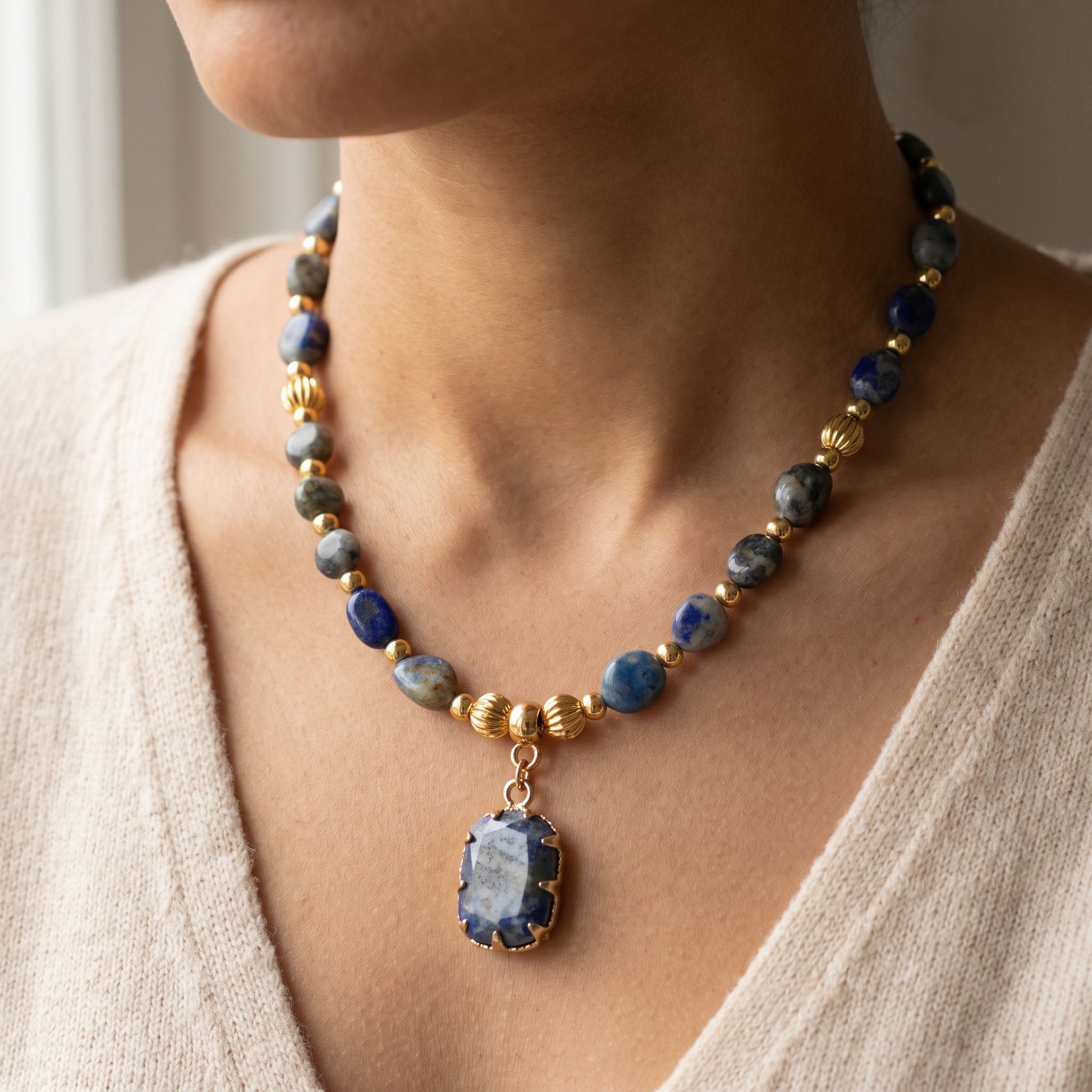 Woman wearing the natural lapis lazuli healing crystal necklace, 45cm length with gold pendant