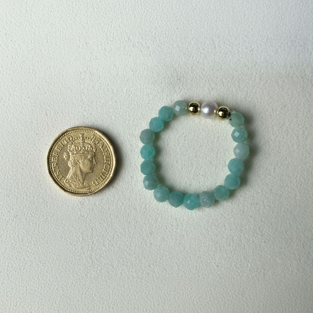 Amazonite and freshwater pearl stretch ring beside a one pound coin for scale – Manushaa Gems
