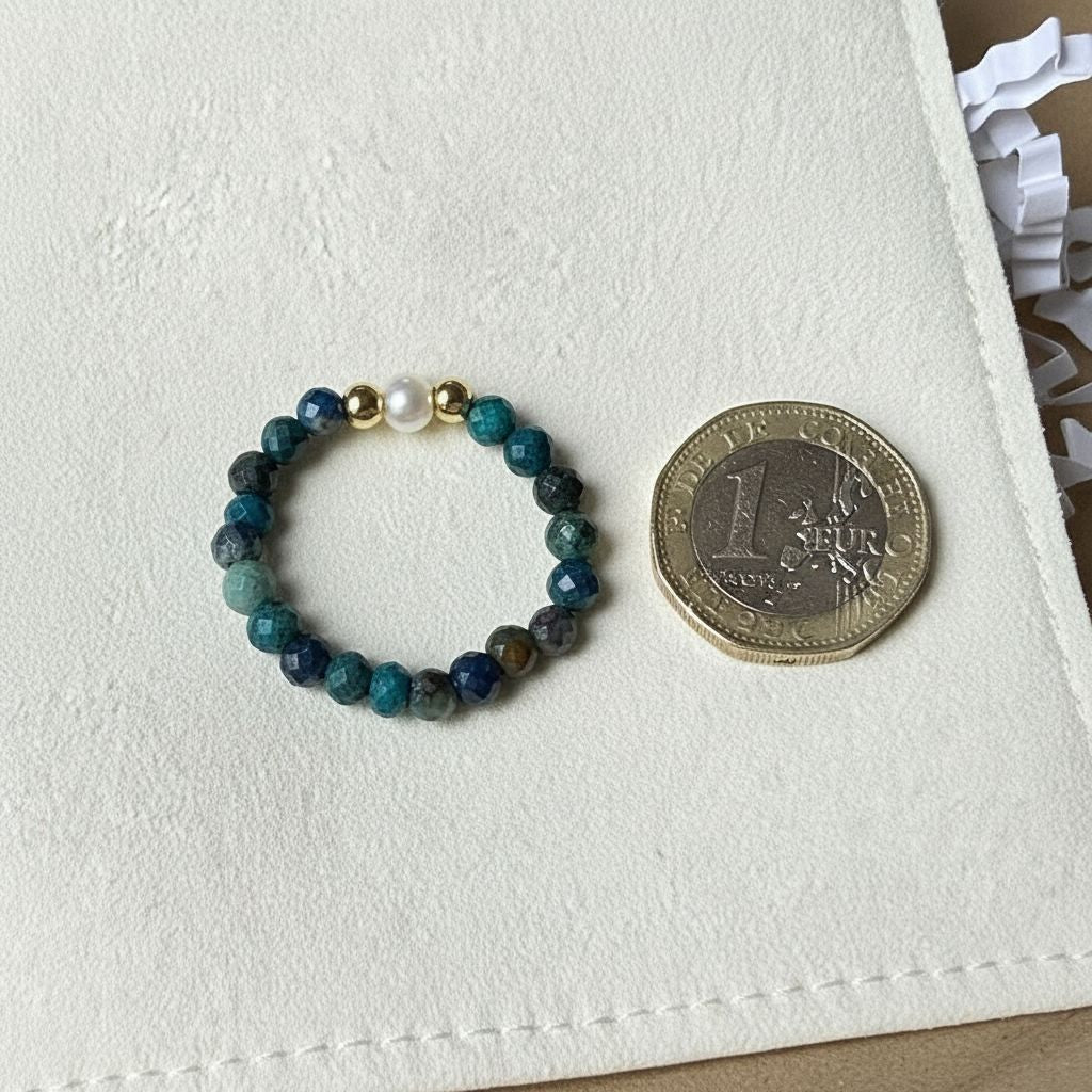 Azurite and freshwater pearl stretch ring beside a one pound coin for scale – Manushaa Gems